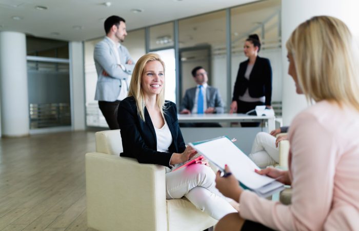 Picture of attractive smiling saleswoman working in office